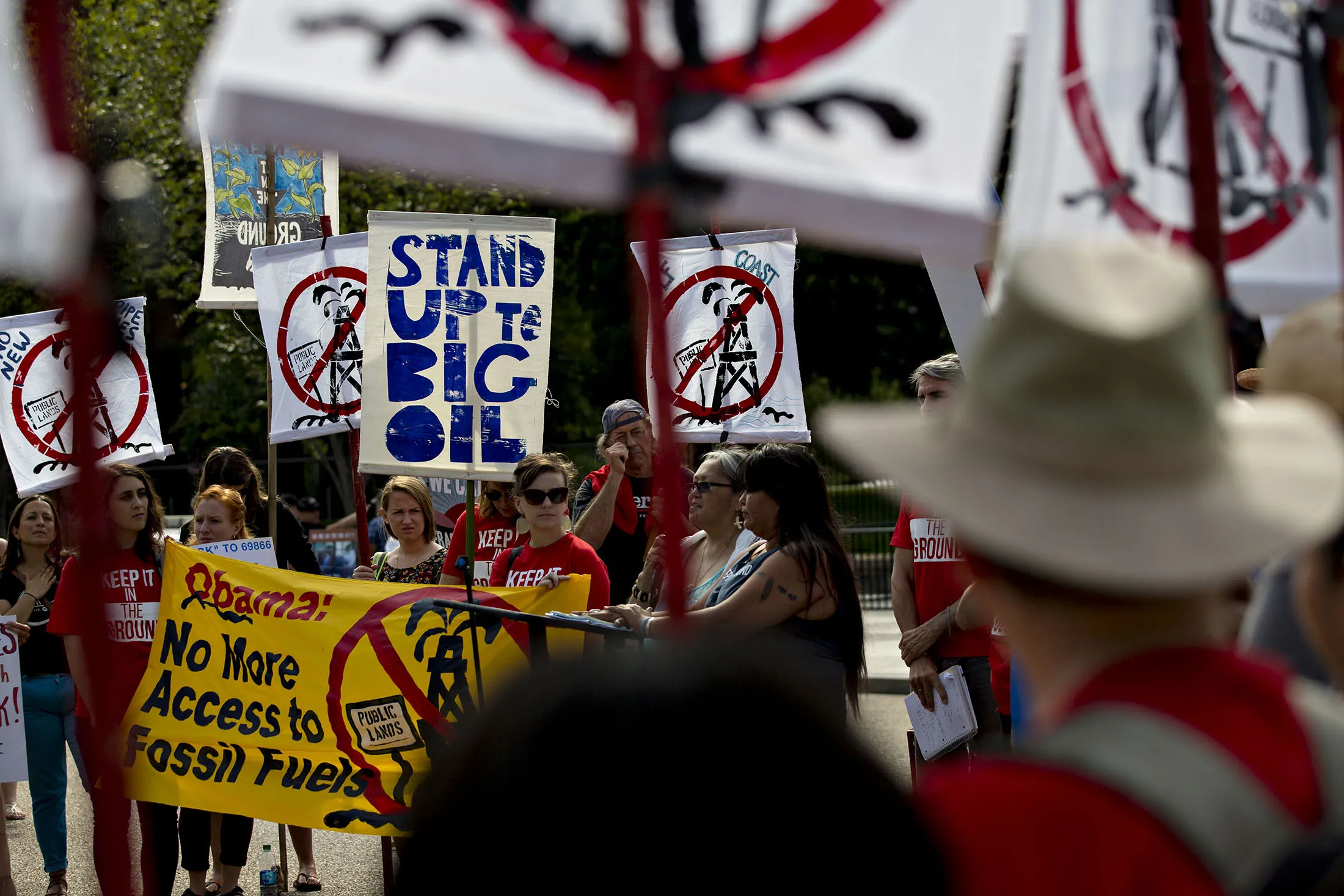 Demonstrators from the Keep It In The Ground campaign hold up signs while protesting in front of the White House in Washington on Thursday, Sept. 15, 2016.

