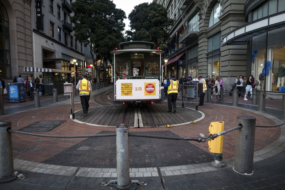 San Francisco Municipal Transit Agency employees turn an empty cable car in San Francisco on March 4. The city has taken advantage of the commuting and tourism lull to complete transportation-related construction projects.