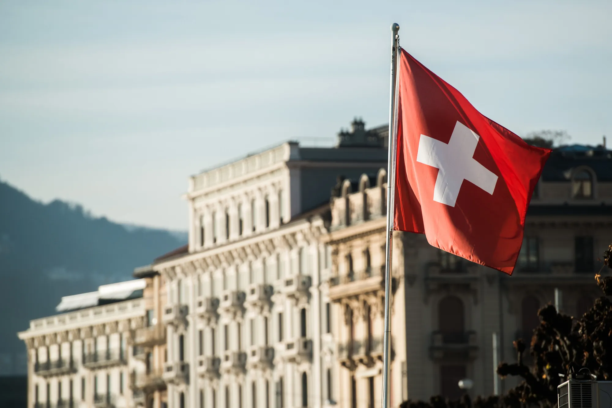 A Swiss national flag flies near residential properties in Lugano, Switzerland
