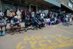 As a liquidity crisis continues, bank customers queue up in Bulawayo on Dec. 27. Zimbabweans must wait long hours to withdraw money from their accounts.