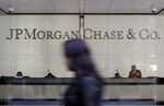 Pedestrians walk past JPMorgan Chase & Co. headquarters in New York, U.S..