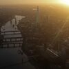 The early morning sun rises on the horizon beyond the Shard, in this aerial photograph looking south east along the River Thames towards Canary Wharf from the City of London, U.K., on Thursday, Dec. 19, 2013. The pound approached a two-year high versus the dollar after Bank of England policy maker Andrew Bailey said the central bank may take steps to prevent U.K. house prices from rising too quickly.