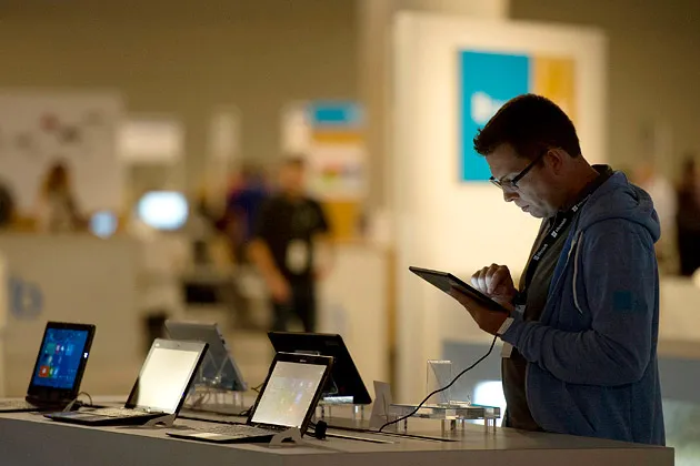 An attendee at the Microsoft Build Developers Conference in San Francisco looks at a Lenovo tablet on June 26