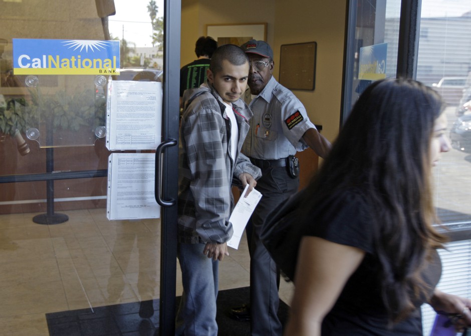 Customers leave a branch of California National Bank of Los Angeles, one day after the Federal Deposit Insurance Corporation closed CalNational and eight smaller related banks, in Los Angeles, Saturday, Oct. 31, 2009. 