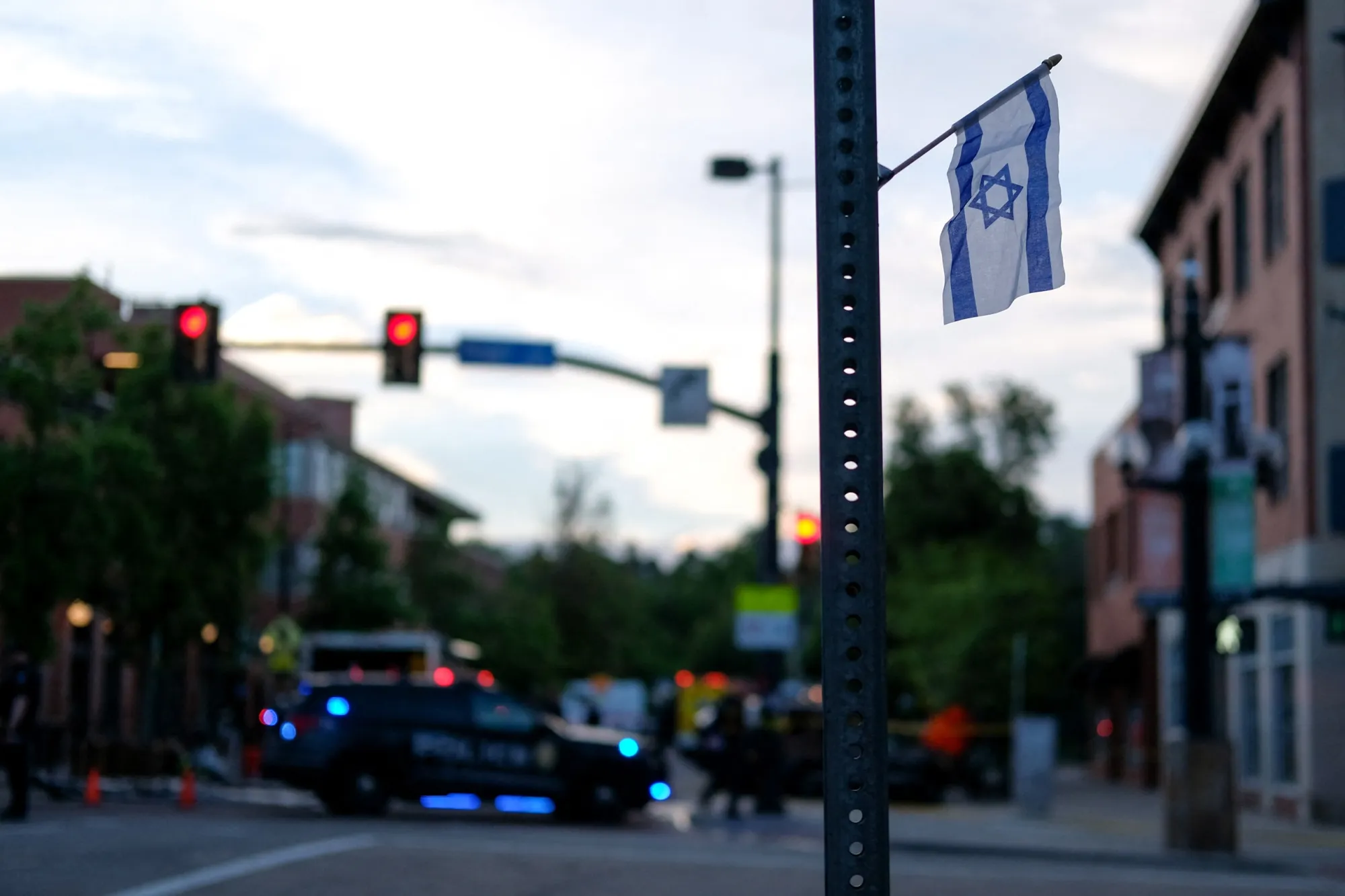 An Israeli flag is fixed to a street sign as police cordon&nbsp;off Pearl Street following an attack&nbsp;in Boulder, Colorado, on June 1.