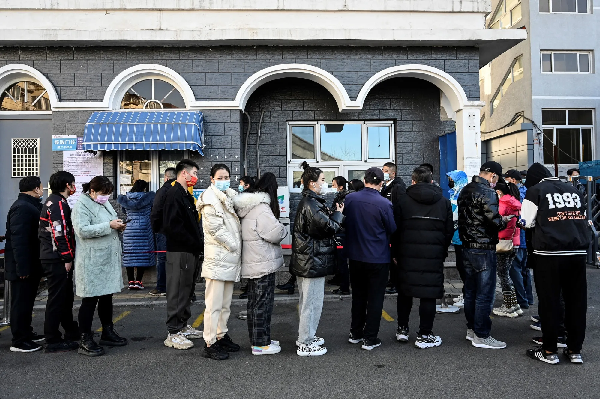 People line up to be tested for&nbsp;Covid-19 outside a hospital in Beijing on Nov. 12.