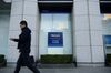 A pedestrian walks past a Mizuho Bank Ltd. and Mizuho Securities Co. branch, units of Mizuho Financial Group Inc., in Tokyo, Japan, on Tuesday, Jan. 29, 2019. Mizuho is scheduled to release earnings figures on Jan. 31.