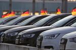 German national flags fly from used Audi AG automobiles on the forecourt of the automaker's showroom in Berlin, Germany, on Tuesday, June 19, 2018. Volkswagen AG named Bram Schot as interim chief at its Audi unit, selecting the luxury brand's sales chief to replace longtime leader Rupert Stadler following his arrest Monday over his role in VWs diesel-emissions cheating.