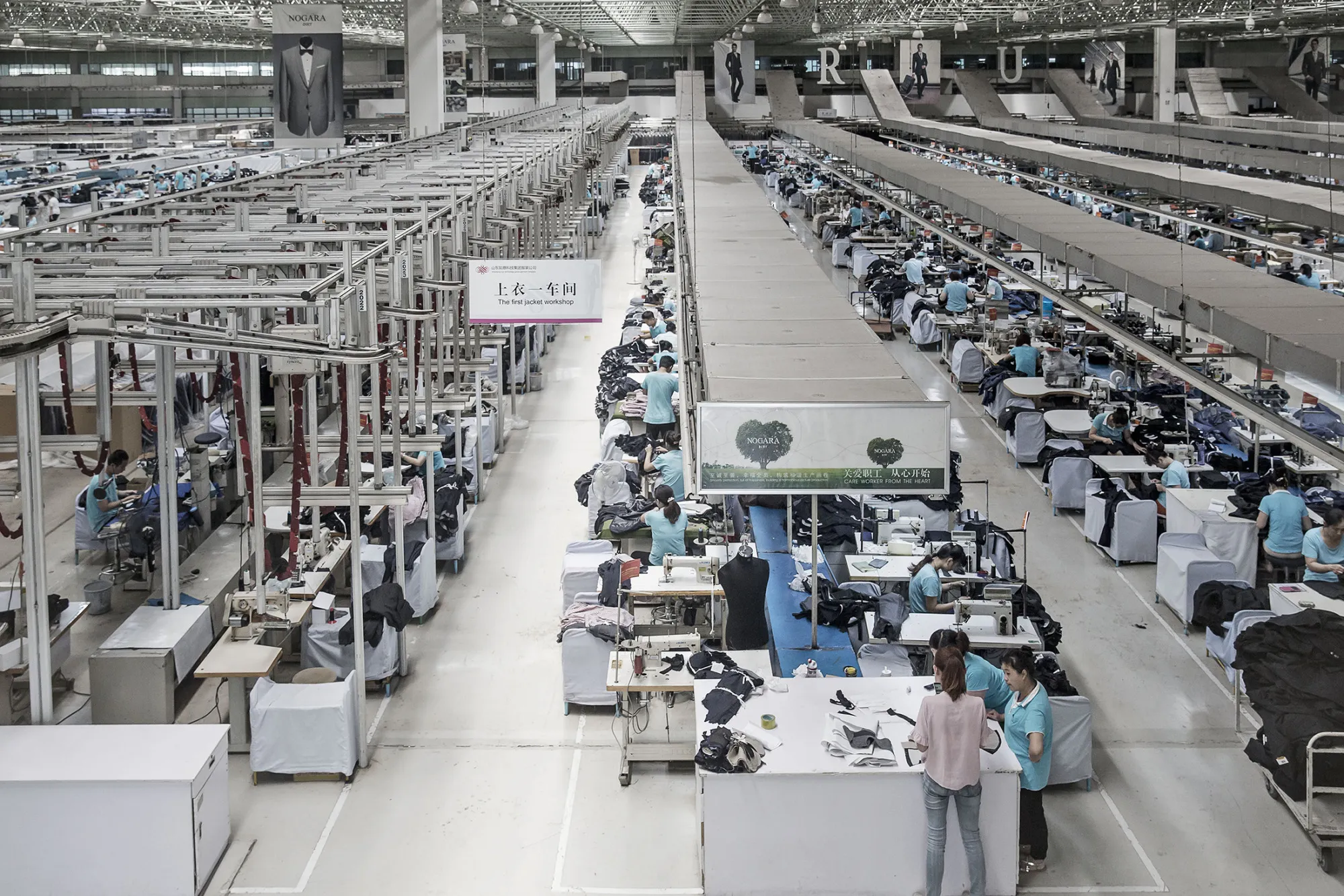 Employees make suits at a factory operated by the Shandong Ruyi Technology Group in Jining, China, on May 30, 2016.
