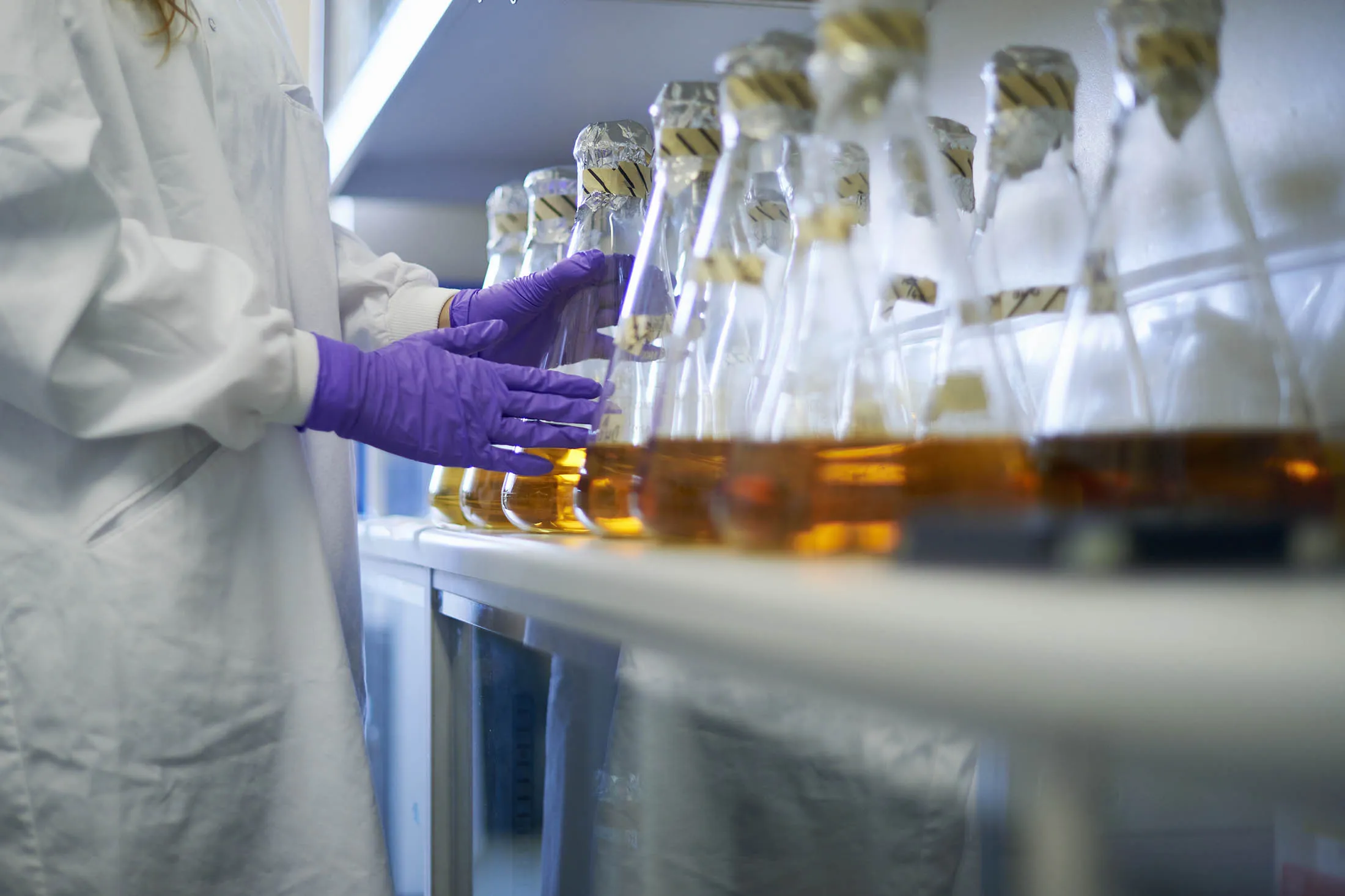 Science student with conical flasks
