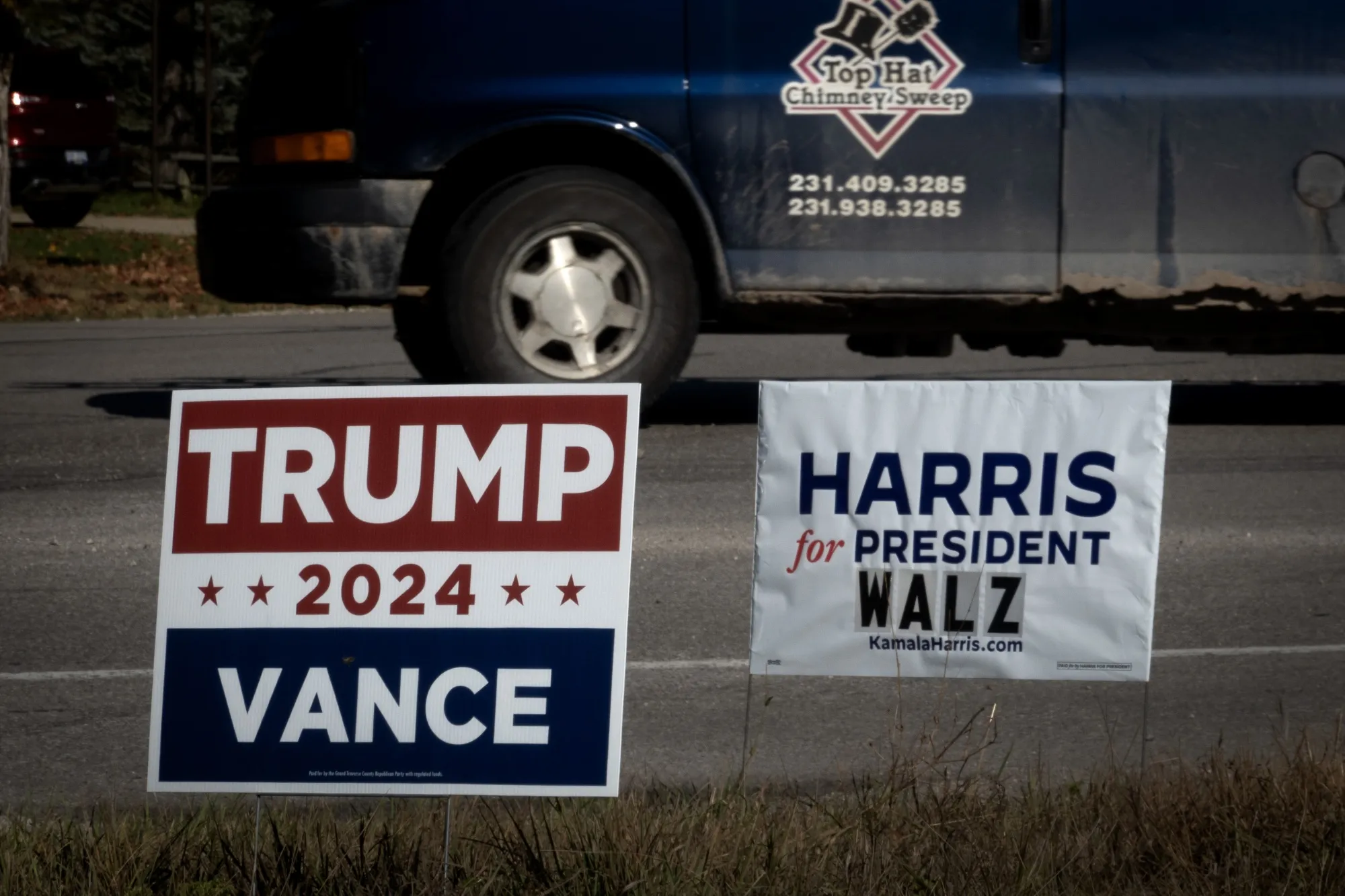 Signs for Democratic presidential candidate Vice President Kamala Harris and Republican presidential candidate former President Donald Trump sit along a rural highway near Traverse City, Michigan.&nbsp;