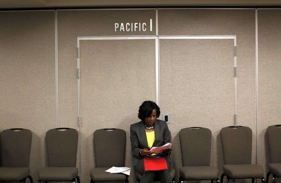 A job seeker fills out an application during a hiring event for marketing, sales and retail positions in San Francisco on June 4, 2015. 