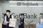Sales staff wearing protective masks work at a SoftBank Corp. store in Tokyo.