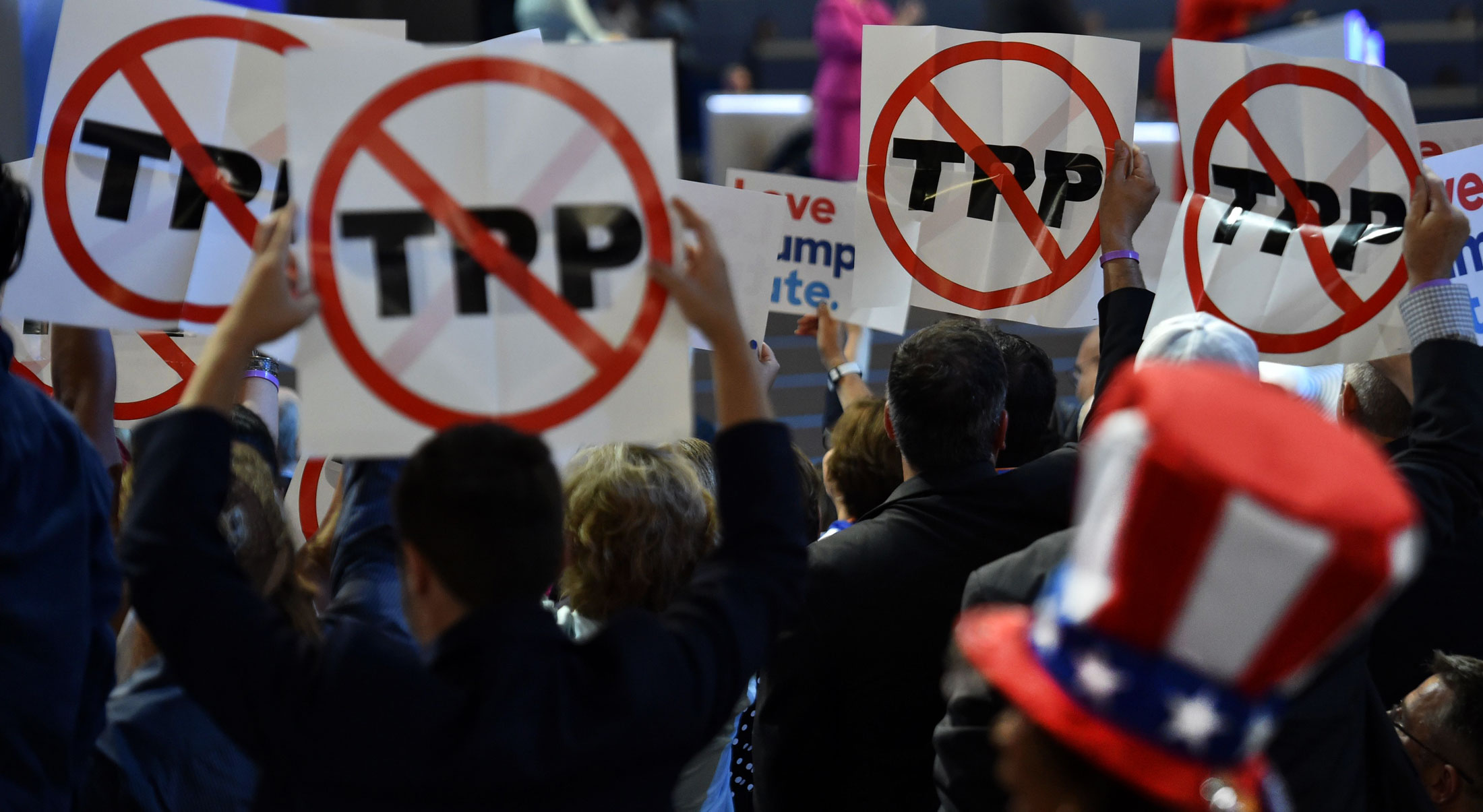 Delegates show their opposition to the Trans-Pacific Partnership agreement during the Democratic National Convention on July 25.
