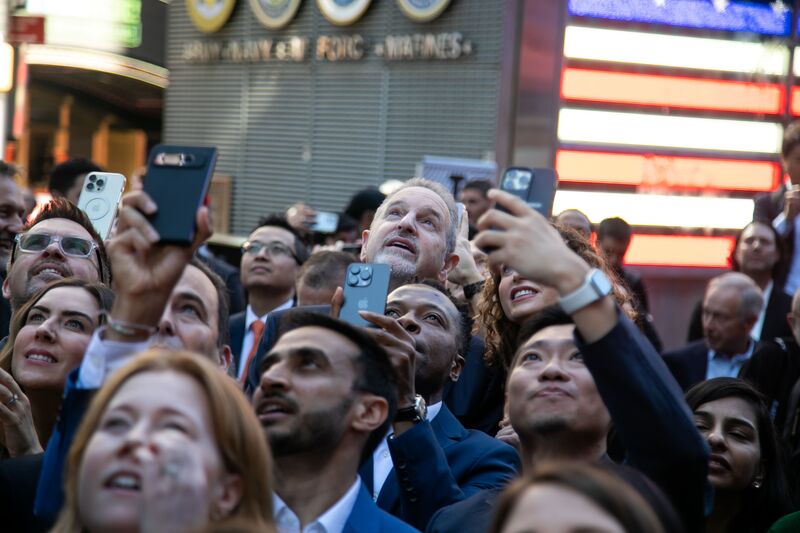 Rene Haas, chief executive officer of Arm Ltd., center, looks up at a screen during the company's IPO 