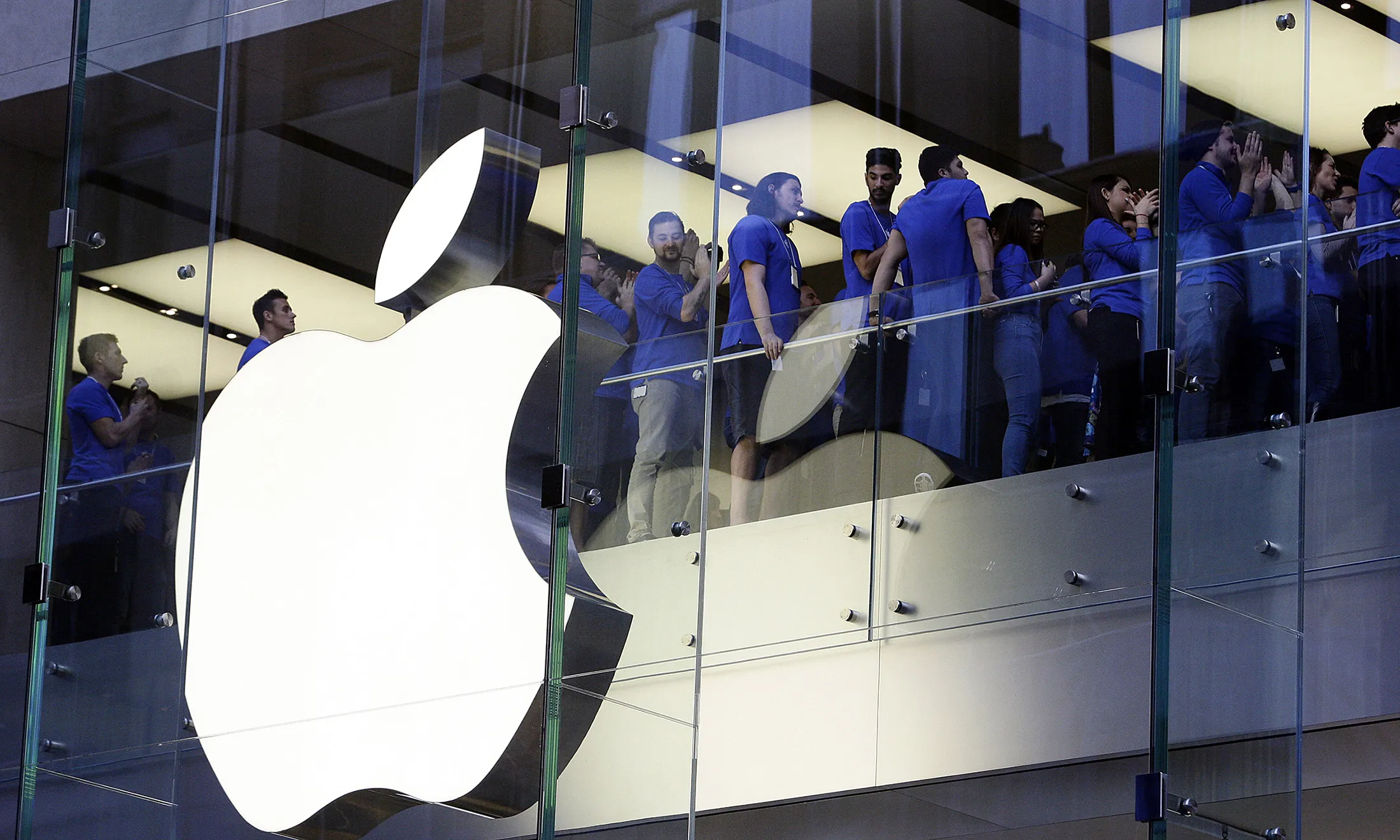 Apple Inc. employees cheer before opening the doors to the company's George Street store for the sales launch of the iPhone 6 and iPhone 6 Plus in Sydney, Australia.
