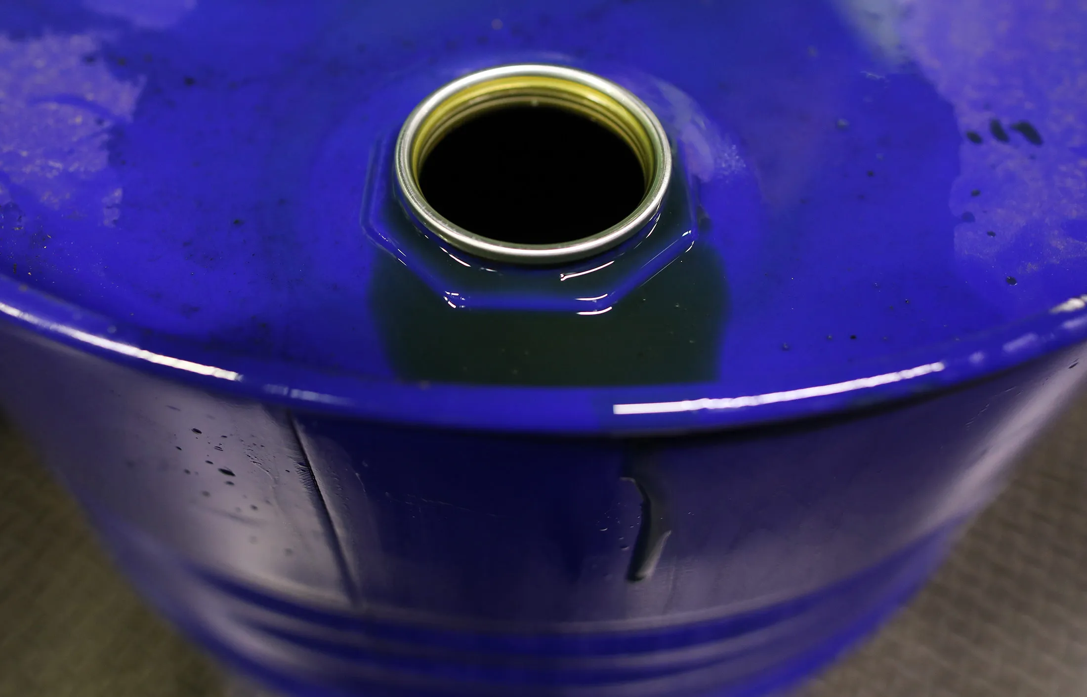 Excess fluid sits on the rim of a barrel of oil based lubricant at Rock Oil Ltd.'s factory in Warrington, U.K., on Monday, March 13, 2017. Oil declined after Saudi Arabia told OPEC it raised production back above 10 million barrels a day in February, reversing about a third of the cuts it made the previous month.
