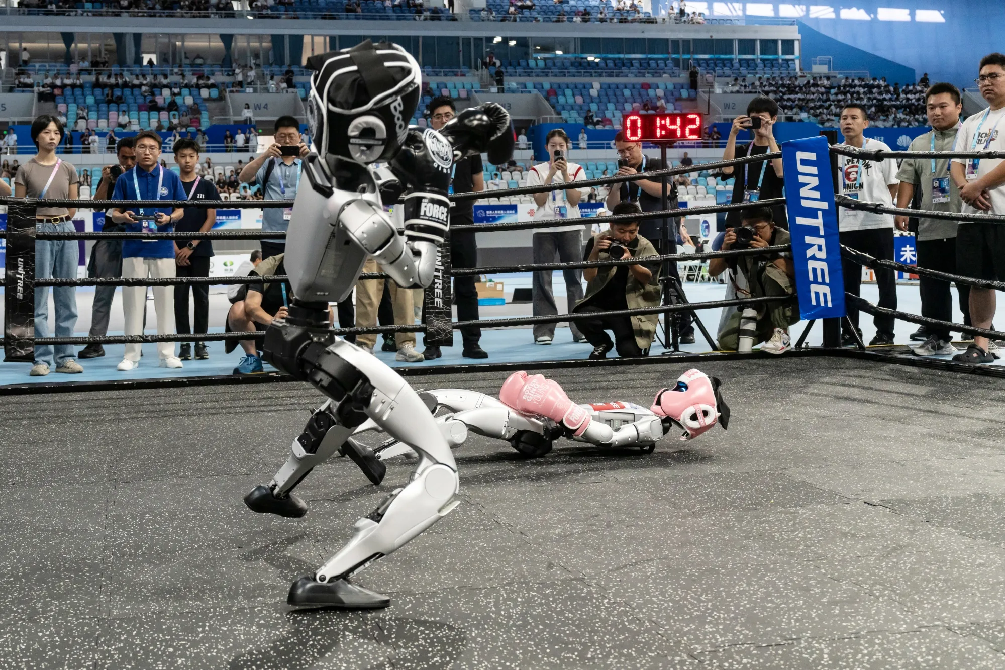 Unitree humanoid robots during a kick-boxing competition at the World Humanoid Robot Games in Beijing, on Aug. 15.