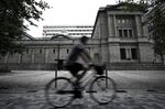 A cyclist rides past the Bank of Japan (BOJ) headquarters in Tokyo, Japan, on Monday, Sept. 14, 2020.