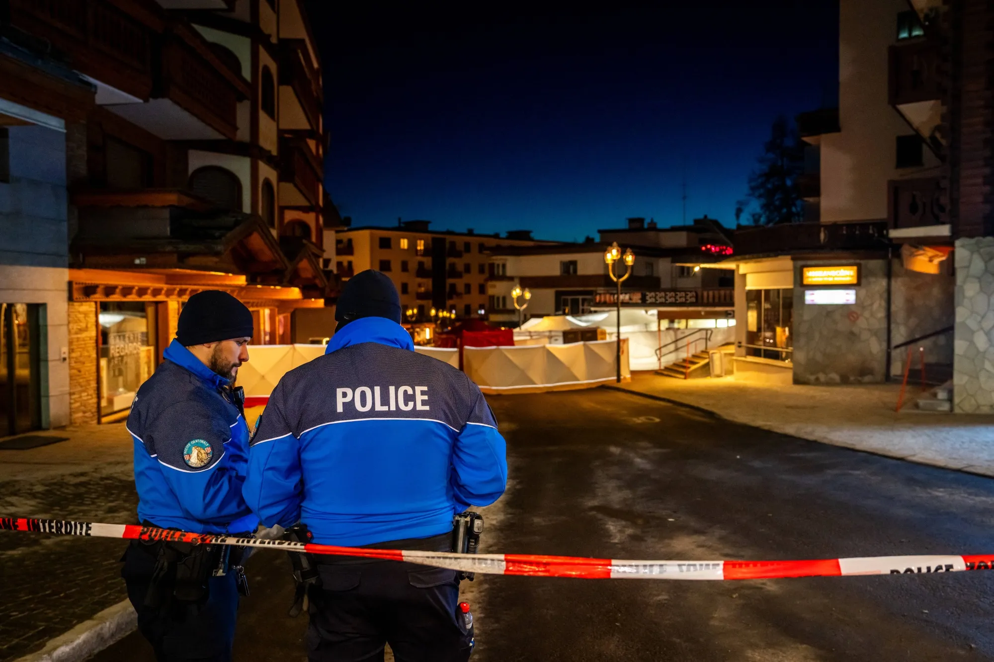 Police control access to the street where a fire ripped through a crowded bar.