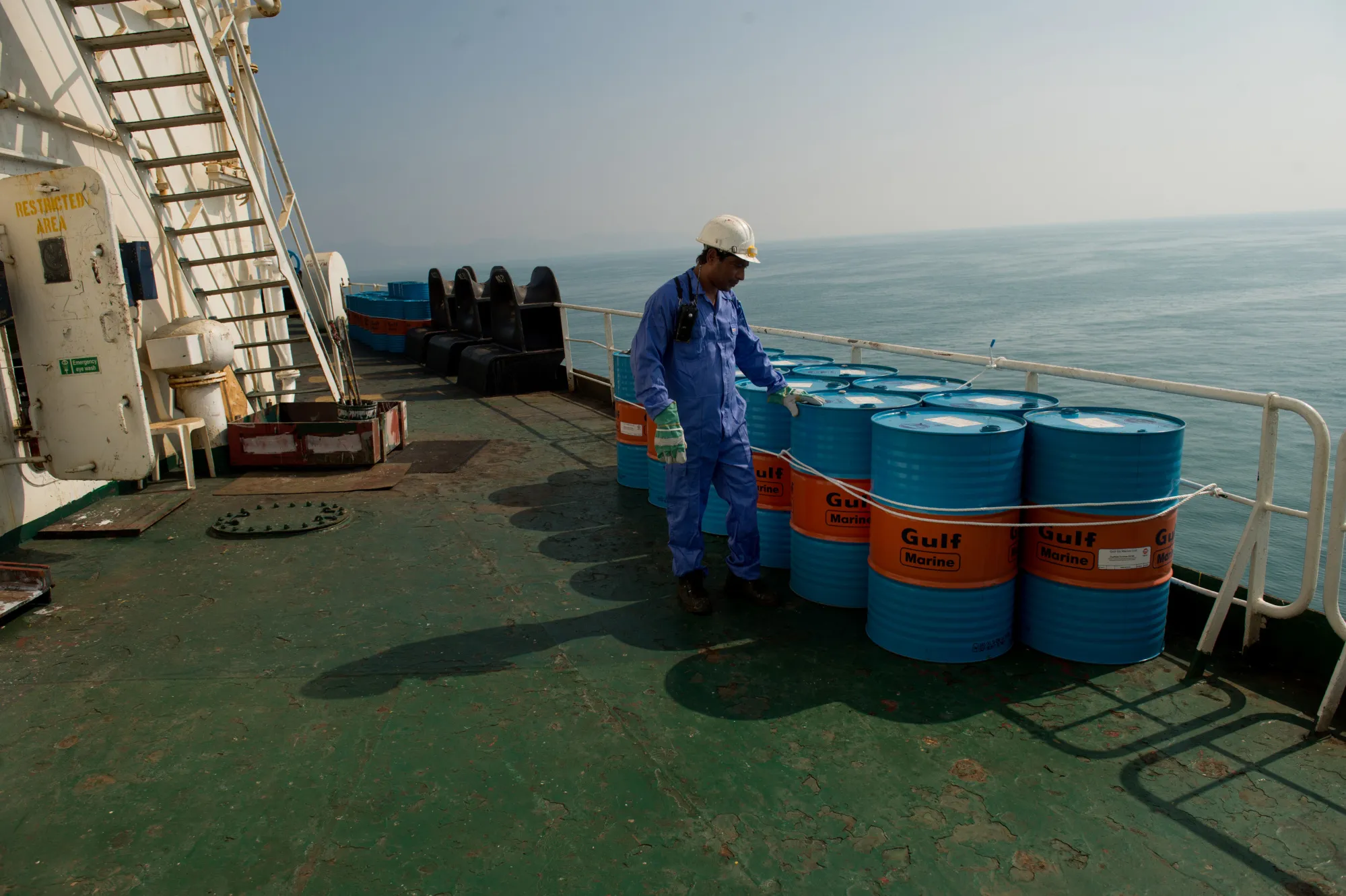 A crew man secures oil drums on the deck near&nbsp;Kharq Island, Iran.&nbsp;