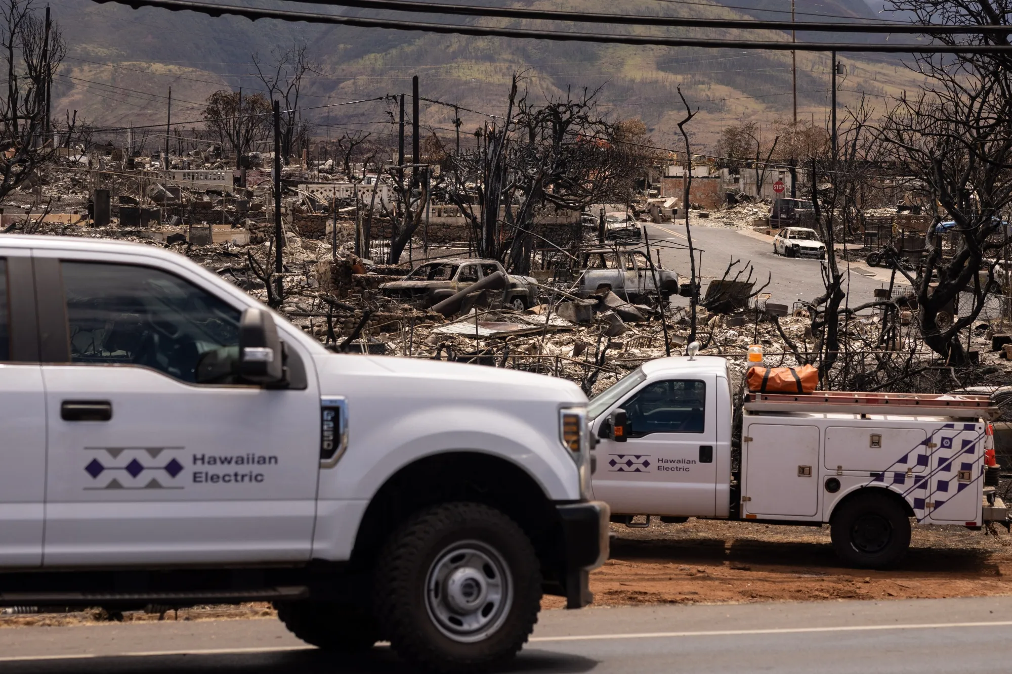 Employees of the Hawaiian Electric restore electric poles in the aftermath of the Maui wildfires in Lahaina, Hawaii in Aug. 2023.&nbsp;