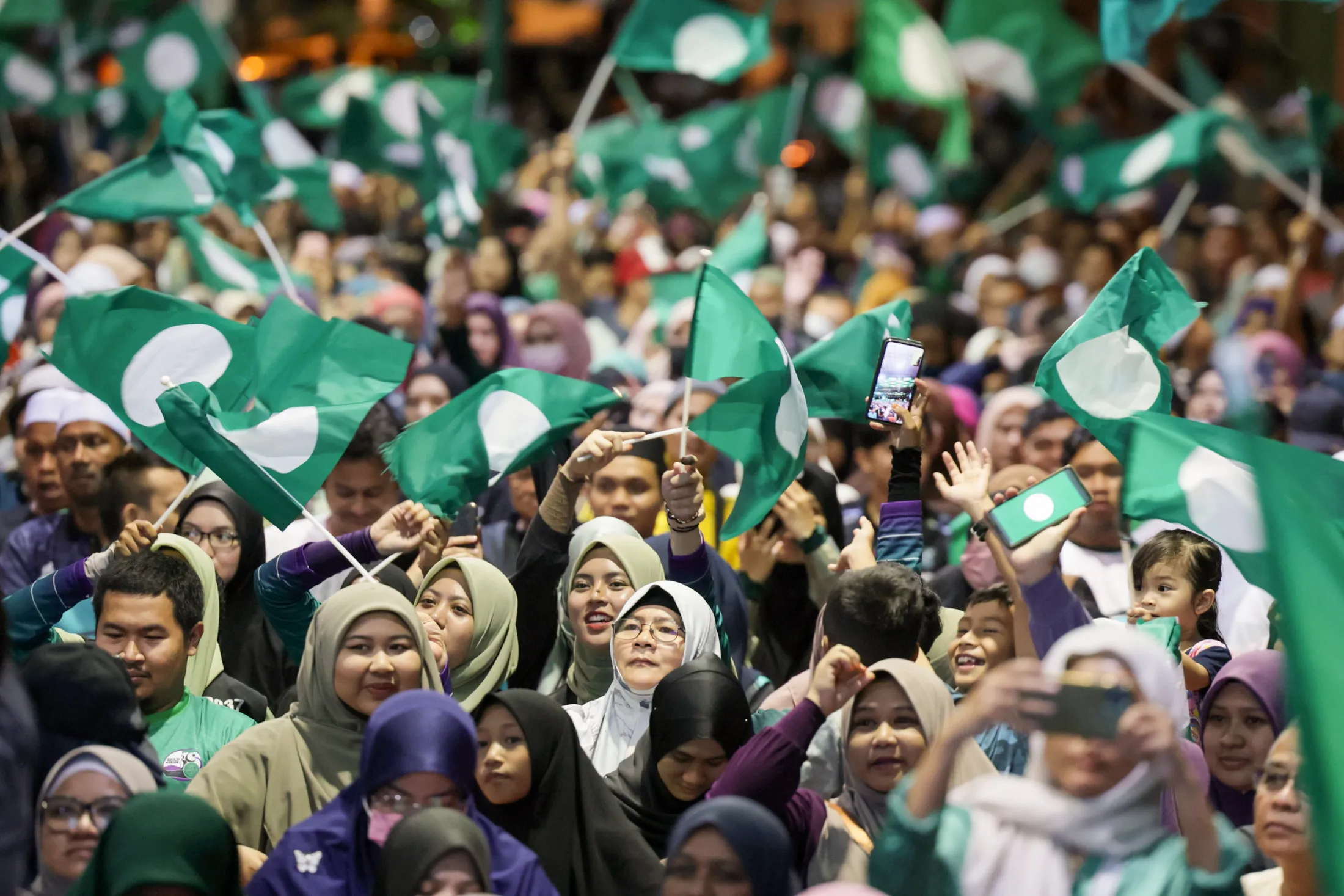 Pan-Malaysian Islamic Party (PAS) supporters celebrate the victory of Abdul Hadi Awang, president of the Pan-Malaysian Islamic Party, during Malaysia’s 15th general election, in Marang, Malaysia, on Nov. 19, 2022. Photographer: Mohd Khairul Fikiri Osman/Bernama Images