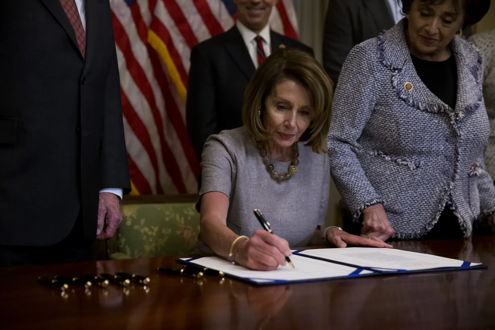 Nancy Pelosi signs a deal to end a partial government shutdown on Jan. 25.