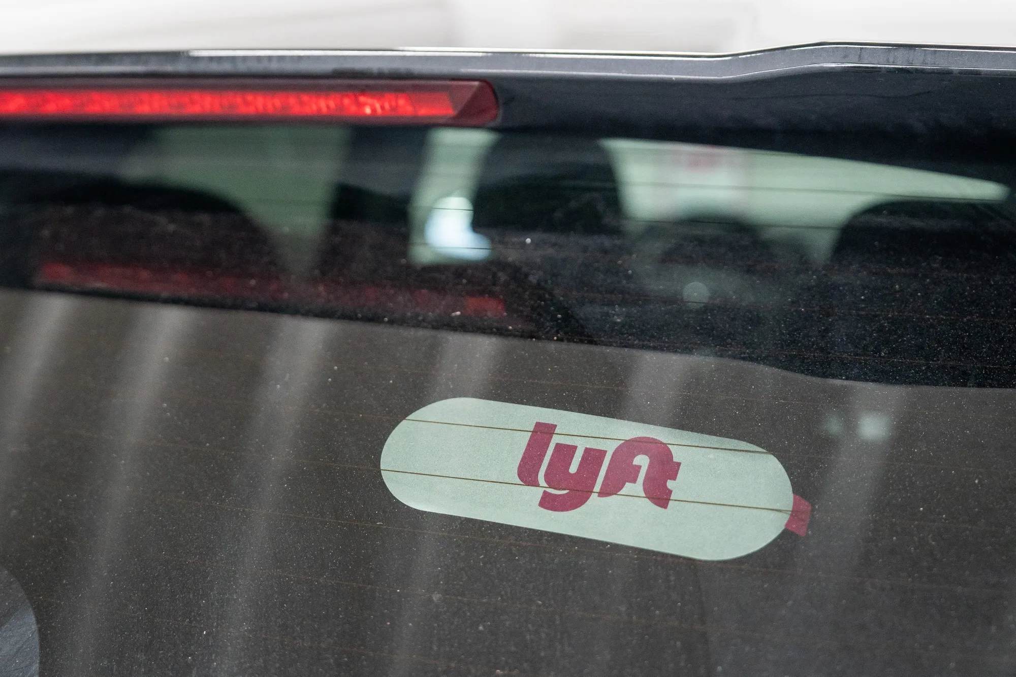 Lyft signage on a vehicle at a rental location in San Francisco.