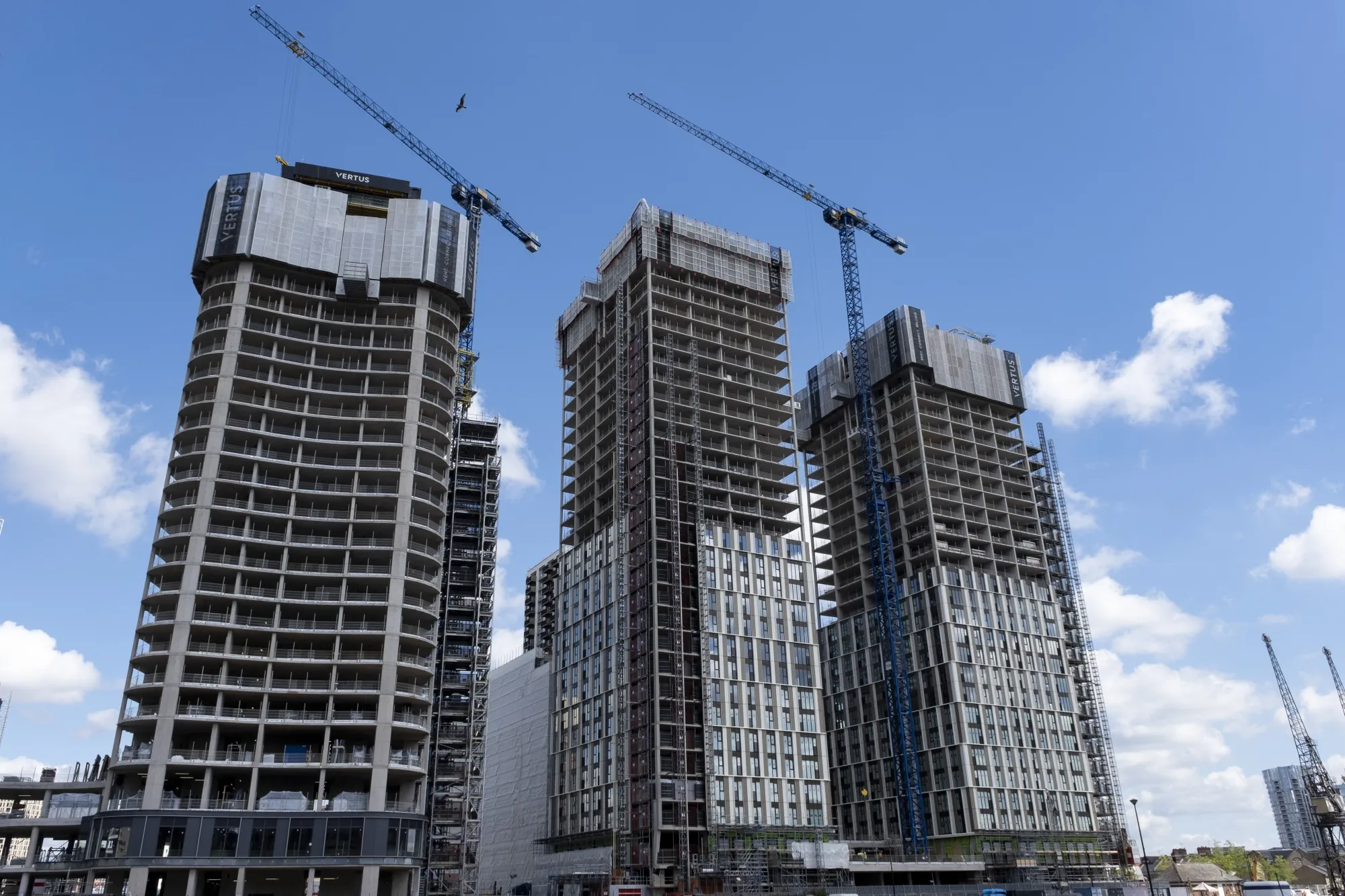 New build construction of high rise apartment buildings along South Dock at the heart of Canary Wharf financial district.