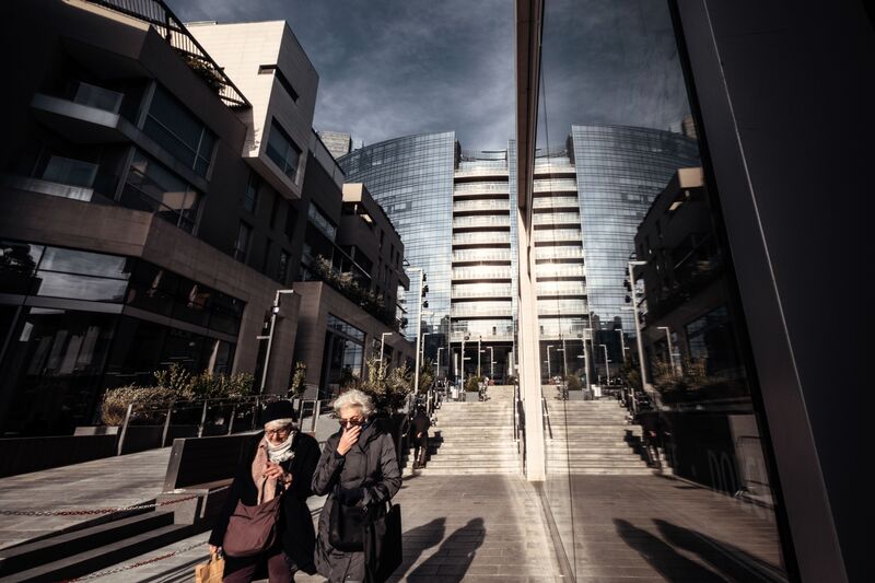 Pedestrians walk in the business district of Milan, Italy, on Feb. 26.