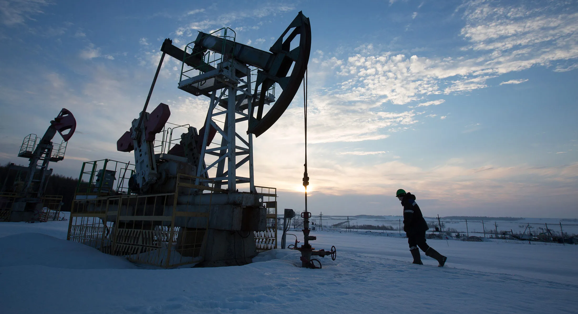 An oil worker inspects a pumping jack during drilling operations in an oilfield operated by Bashneft PAO in the village of Otrada, 150kms from Ufa, Russia.
