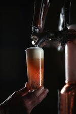 A glass of James Squire Hop Thief American pale ale is poured from a beer tap at The Malt Shovel Brewery, operated by Lion Pty Ltd., in Sydney, Australia, on Thursday, April 19, 2018.