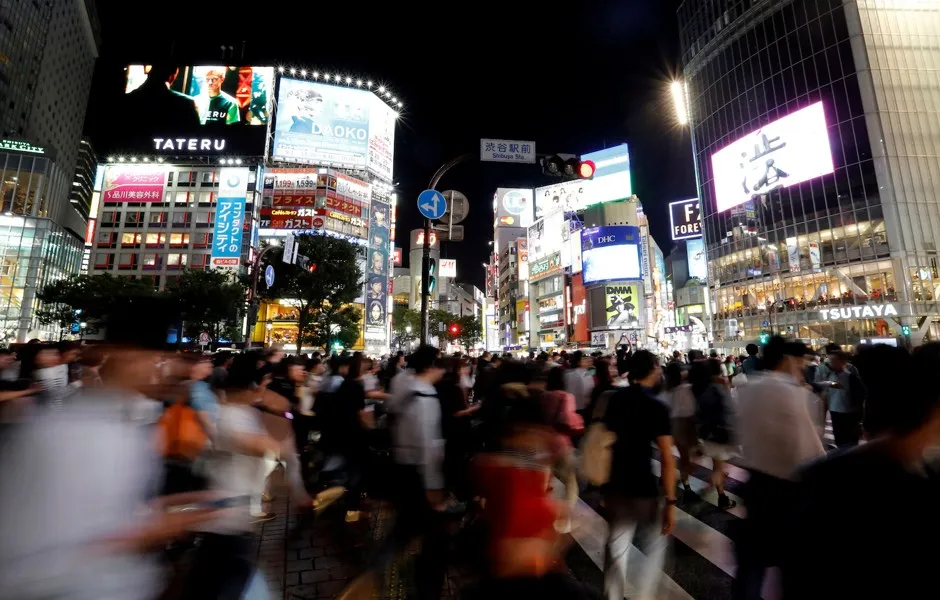 Pedestrians at a scramble crossing in the Shibuya shopping district in Tokyo.