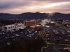 A drone photograph shows the exterior of the hospital and its parking lot in the foreground with the Appalachian Mountains in the background.