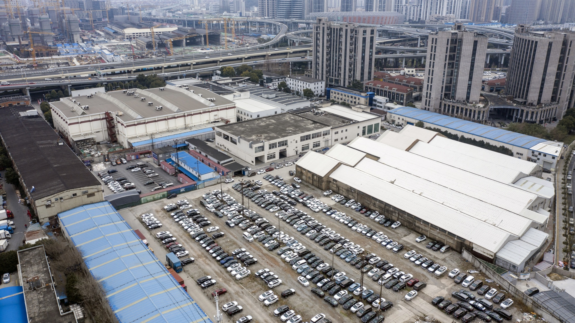 Vehicles at a used-car sales lot in this aerial photograph taken in Shanghai, China.