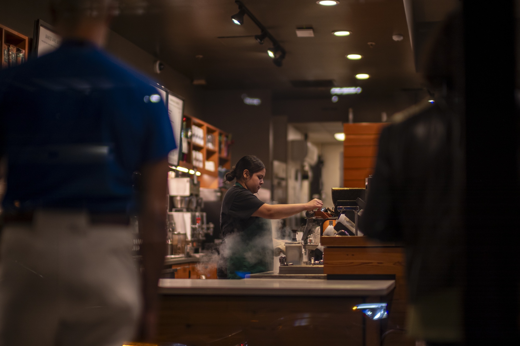 A barista works at a coffee shop in San Francisco.