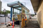 City workers board up the broken windows of a Chicago Transit Authority (CTA) train entrance in the Wicker Park neighborhood of Chicago on June 5.