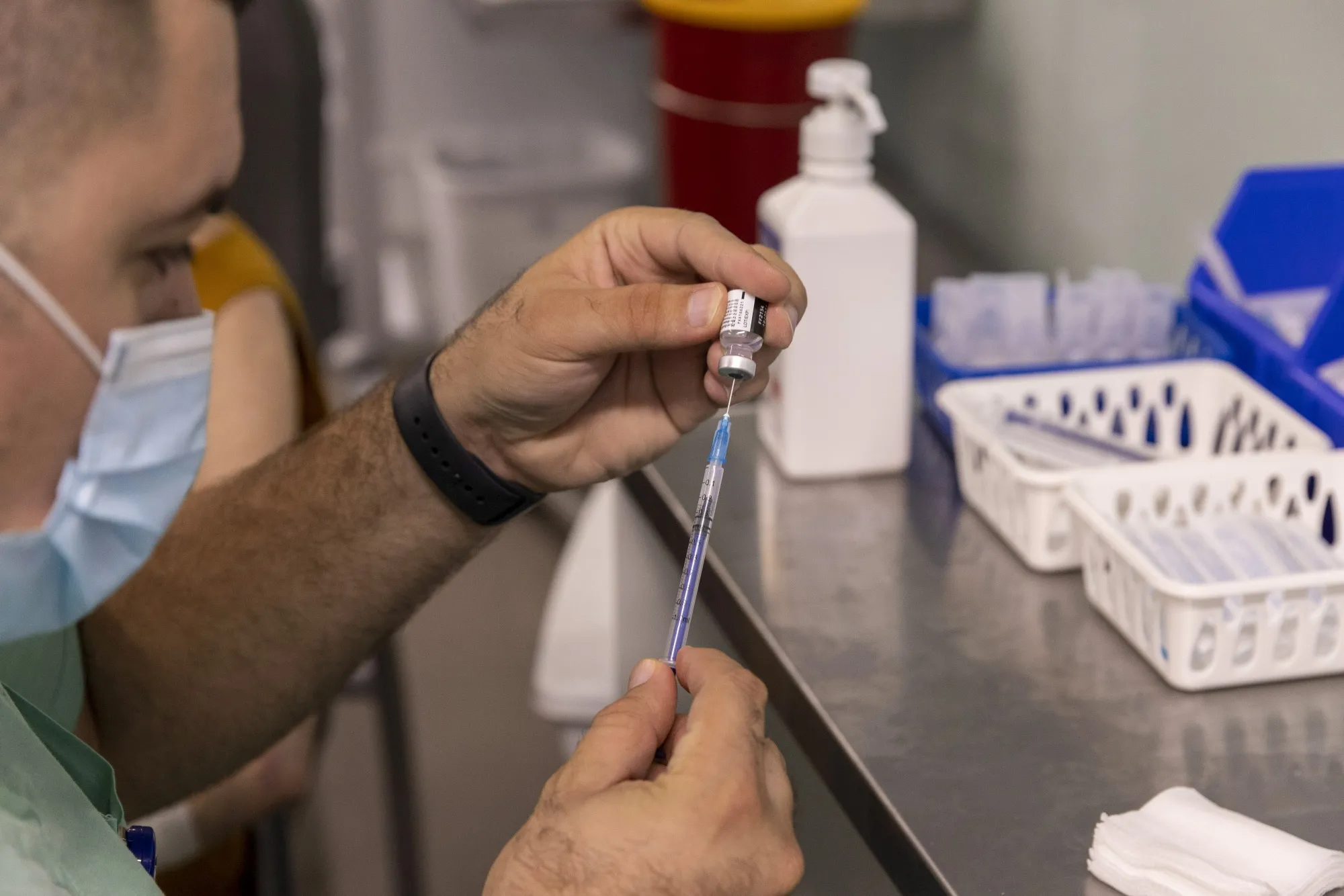 A health worker prepares a booster dose of the Pfizer-BioNTech Covid-19 vaccine at Ichilov medical center in Tel Aviv.