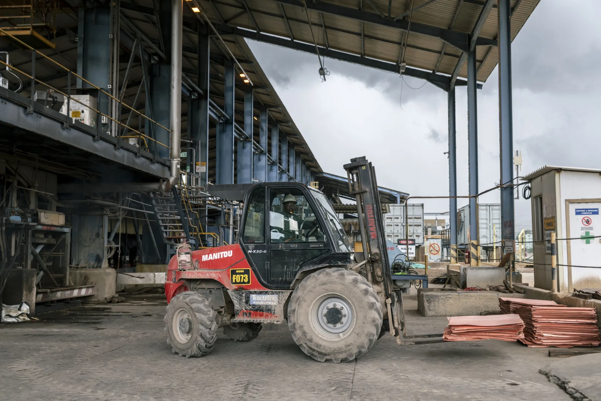 A miner transports copper plates at the open-pit copper and cobalt mine outside Kolwezi in Lualaba province, Democratic Republic of Congo.