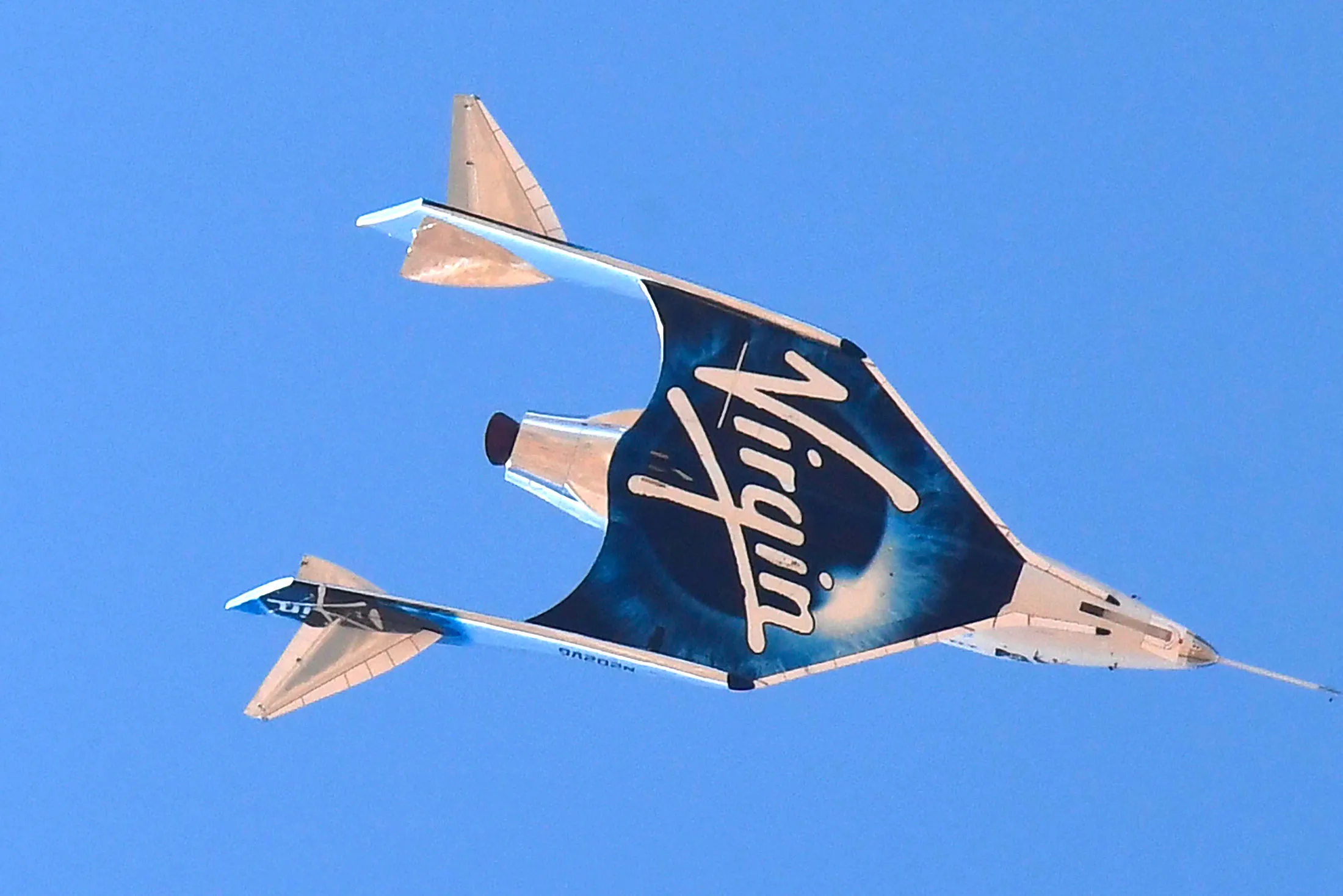 The Virgin Galactic SpaceShipTwo space plane Unity returns to earth above Spaceport America, near Truth and Consequences, New Mexico in&nbsp;2021.