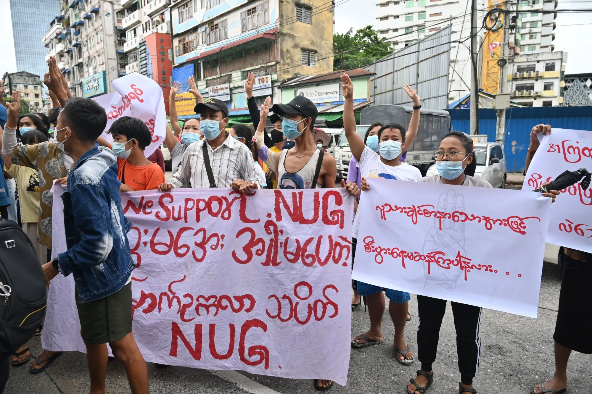 Protesters hold a banner supporting the National Unity Government in Yangon.