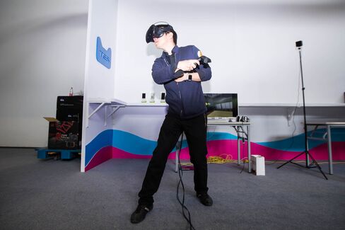 A visitor tries out an HTC Vive VR device during the 1st TES conference held by Tmall.com of Alibaba Group in Hangzhou in April 2016.