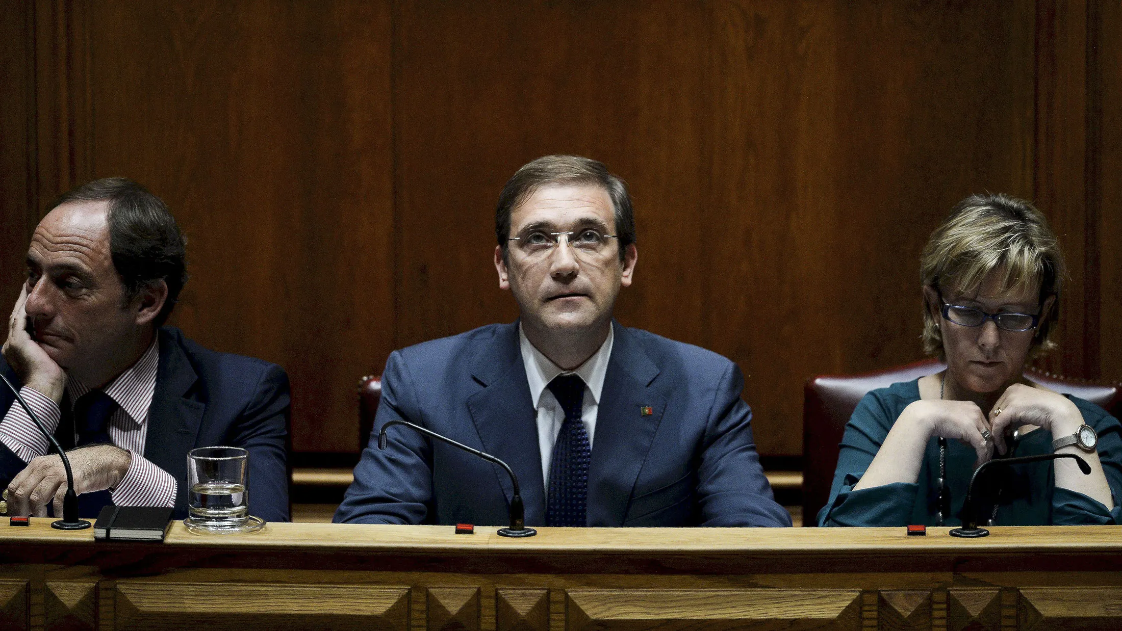 Portuguese Prime Minister Pedro Passos Coelho. center, flanked by Portuguese vice prime minister Paulo Portas. left, and Portuguese finance minister Maria Luis Albuquerque, right, during a debate at the Portuguese Parliament in Lisbon on November 9, 2015.
