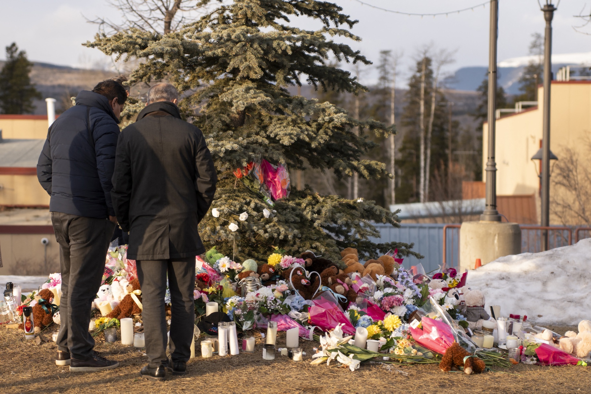 People pay their respects at a community vigil in Tumbler Ridge