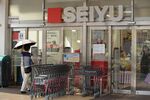 A customer walks toward a Seiyu GK supermarket in Tokyo, Japan on Thursday, July 12, 2018.