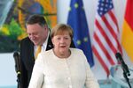 Mike Pompeo and Angela Merkel arrive to deliver a statement ahead of a meeting at the Chancellery in Berlin on May 31.