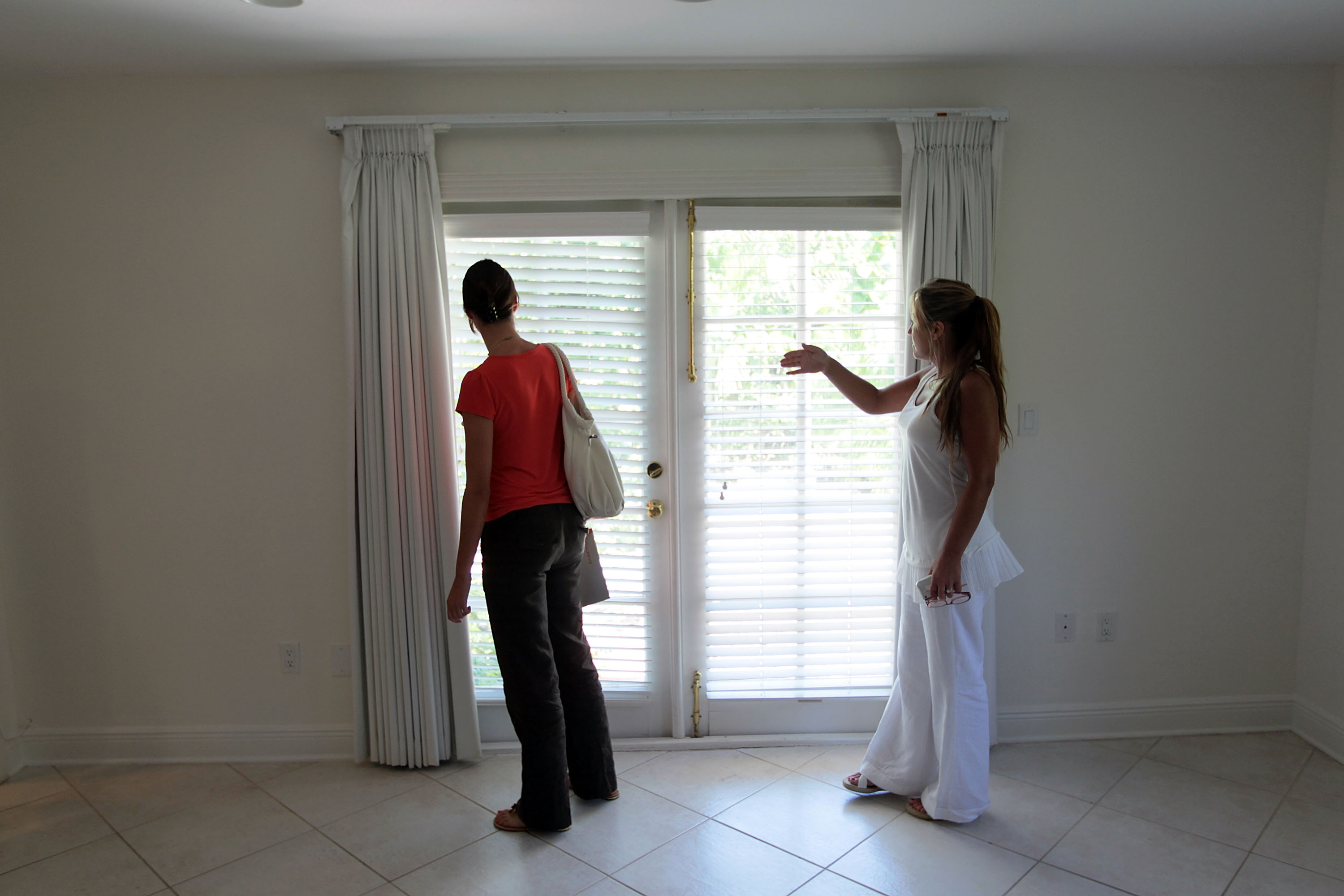 A real estate agent&nbsp;shows a home to a potential buyer&nbsp;in Miami, Florida.