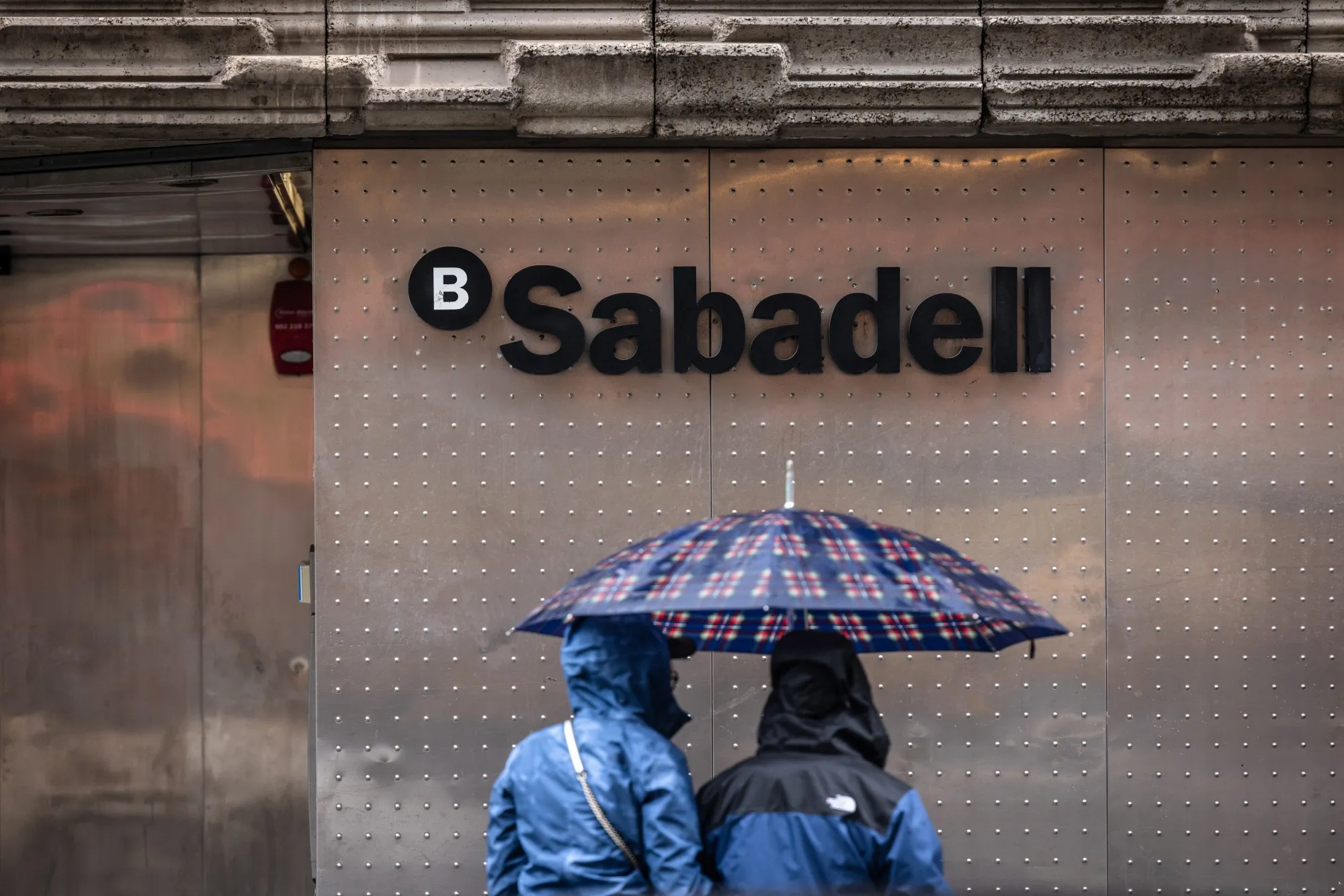 An ATM&nbsp;outside a Banco Sabadell branch in Barcelona, Spain.