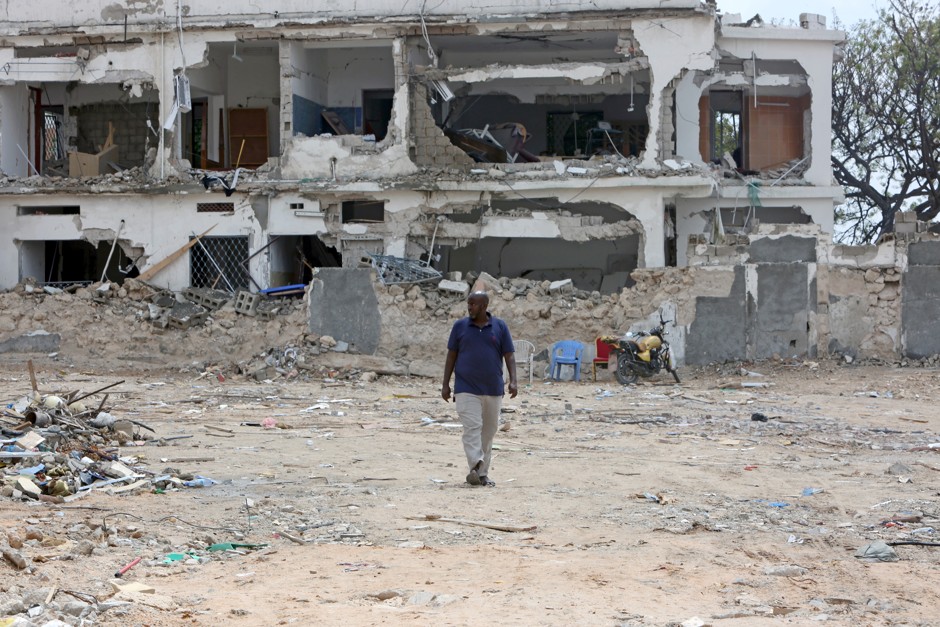 A man walks at the site of the October 14 twin bombings in Mogadishu, Somalia. 